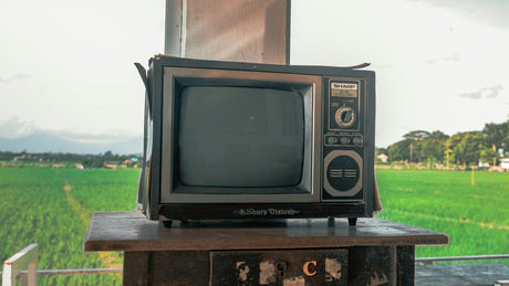 an old television sitting on top of a wooden table