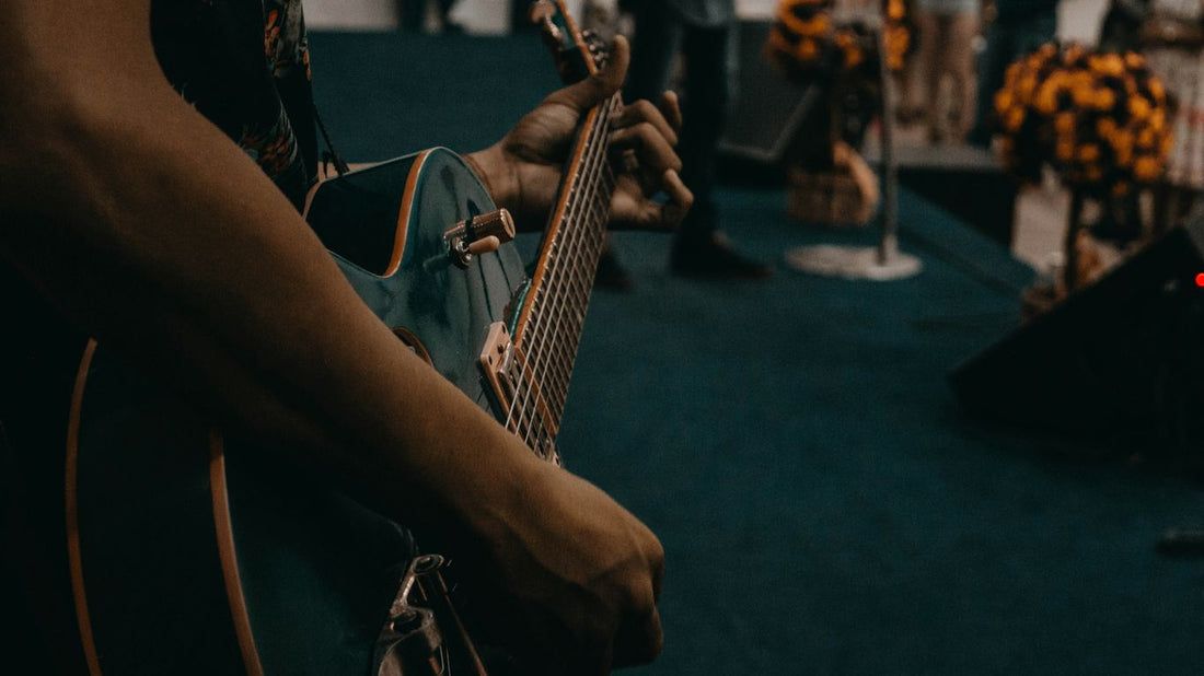 person playing black guitar