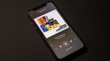 space gray iPhone X showing Spotify application