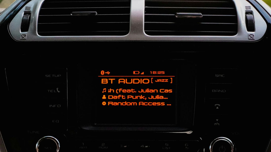 Car stereo displaying bt audio and song information.