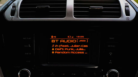 Car stereo displaying bt audio and song information.