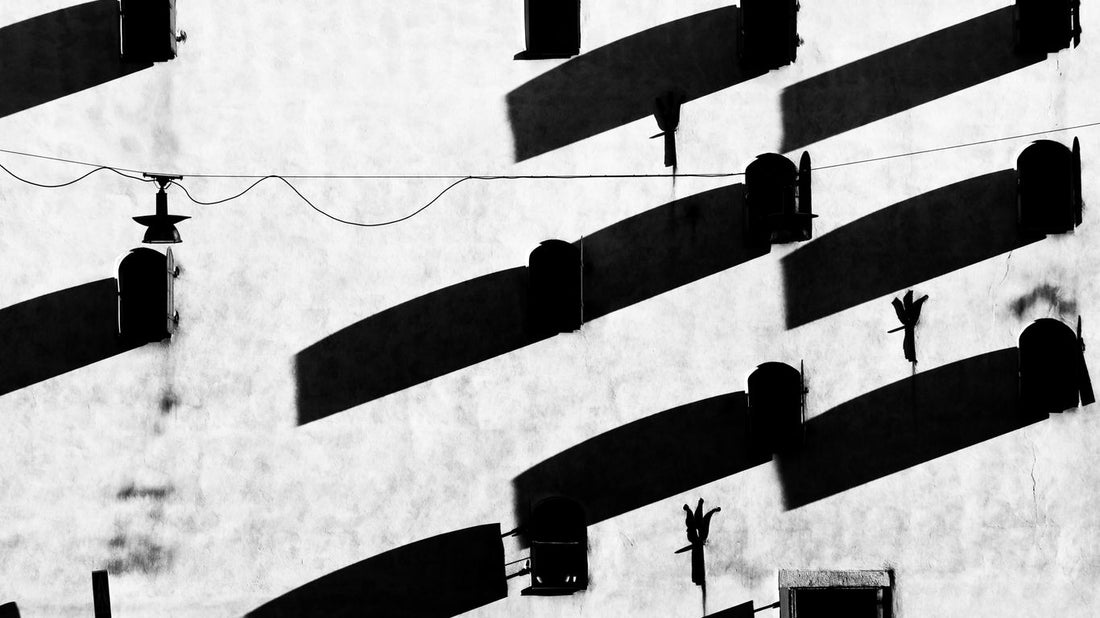 a black and white photo of shadows on a wall